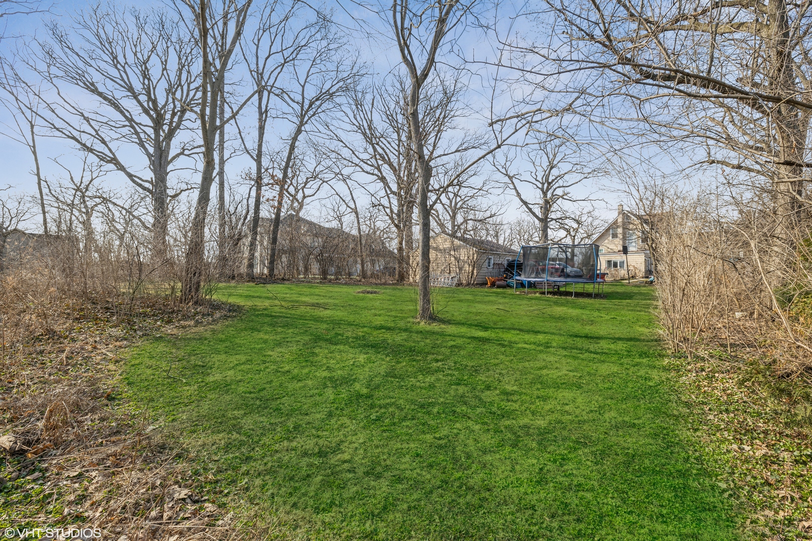 a backyard of apartments with large trees