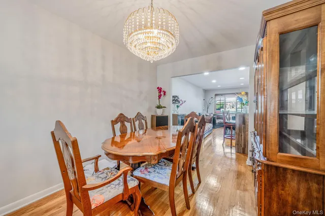 a view of a dining room with furniture and a chandelier