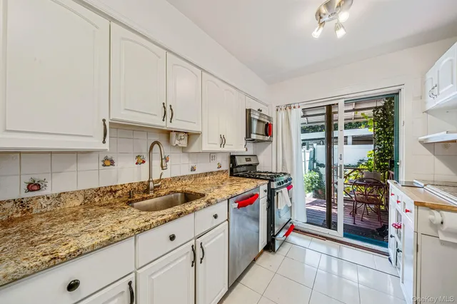 a kitchen with a stove top oven sink and cabinets