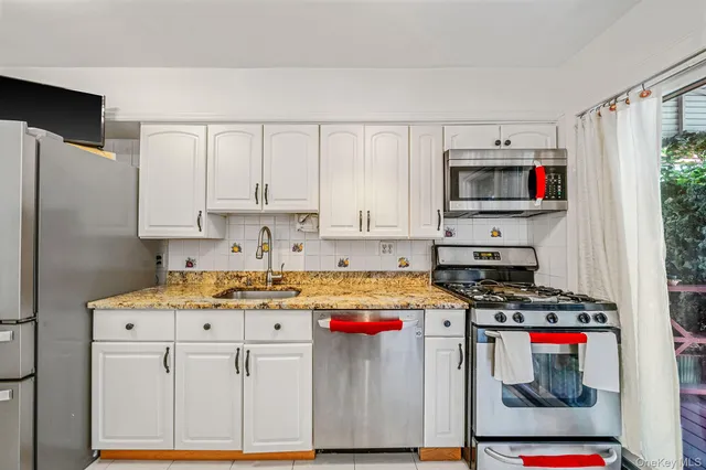 a kitchen with stainless steel appliances granite countertop a stove and a refrigerator
