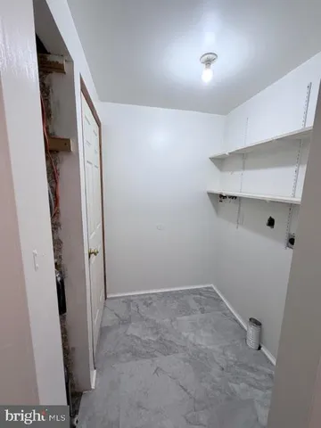 a view of storage and utility room with empty racks