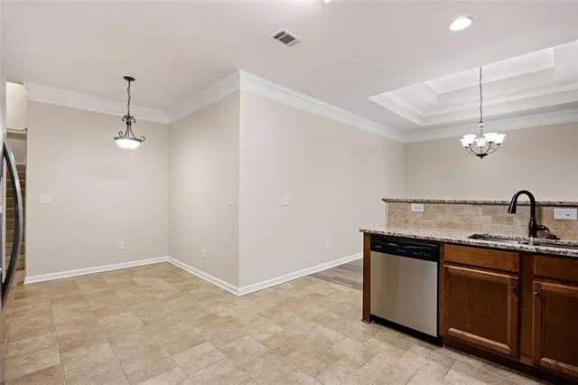 a view of a kitchen with a sink and chandelier