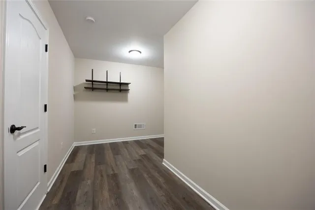 a view of storage and utility room with wooden floor