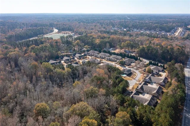 an aerial view of house with yard and mountain view in back