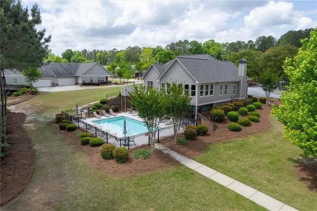 an aerial view of a house with a yard and lake view