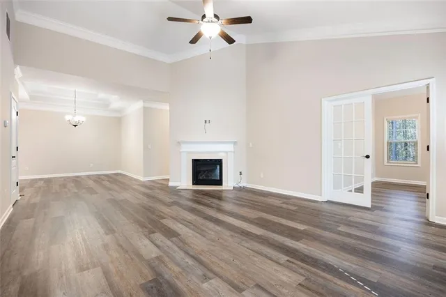 a view of empty room with wooden floor and fireplace