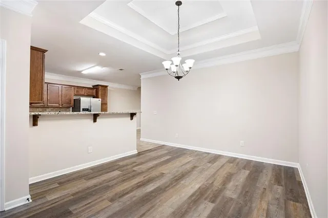 a view of a kitchen with a sink and dishwasher with wooden floor