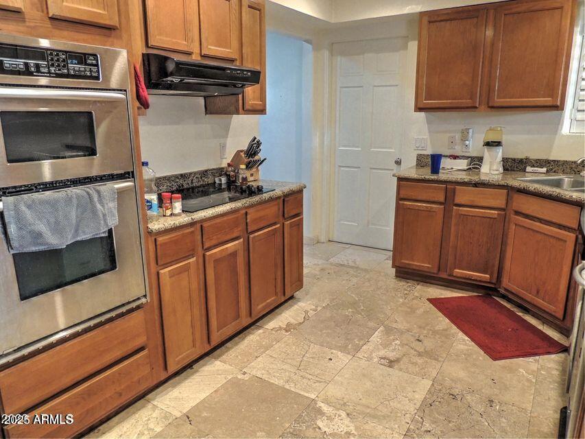 1224 South Maple Avenue Tempe, AZ 85281 - Photo 11 of 31 a kitchen with stainless steel appliances a stove a microwave and sink