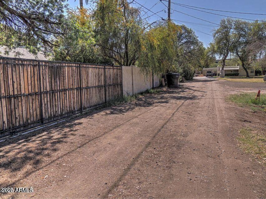 1224 South Maple Avenue Tempe, AZ 85281 - Photo 15 of 31 a view of a backyard with trees and wooden fence