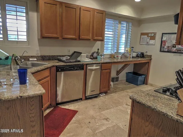 a kitchen with stainless steel appliances a stove a microwave and sink