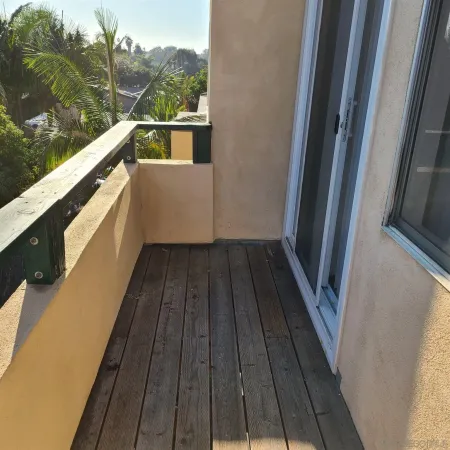 a view of balcony with wooden floor and yard