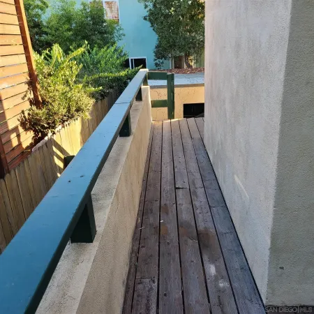 a balcony with wooden floor
