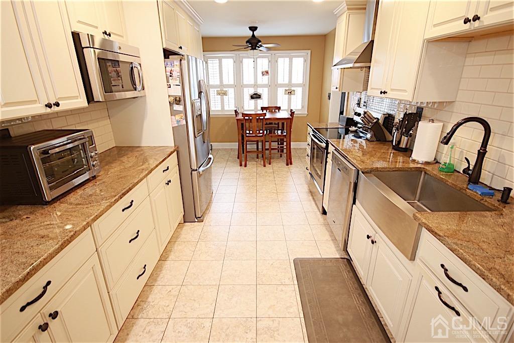 177 Midfield Road Colonia, NJ 07067 - Photo 2 of 20 a kitchen with stainless steel appliances granite countertop a sink and wooden cabinets
