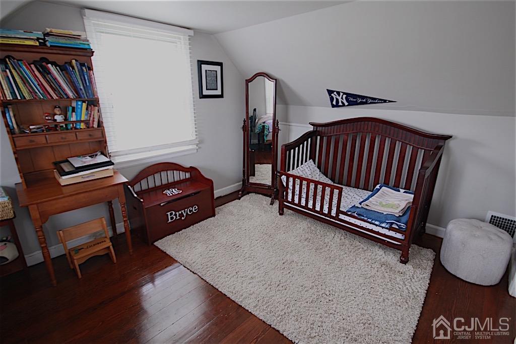 177 Midfield Road Colonia, NJ 07067 - Photo 11 of 20 a bedroom with furniture and a book shelf