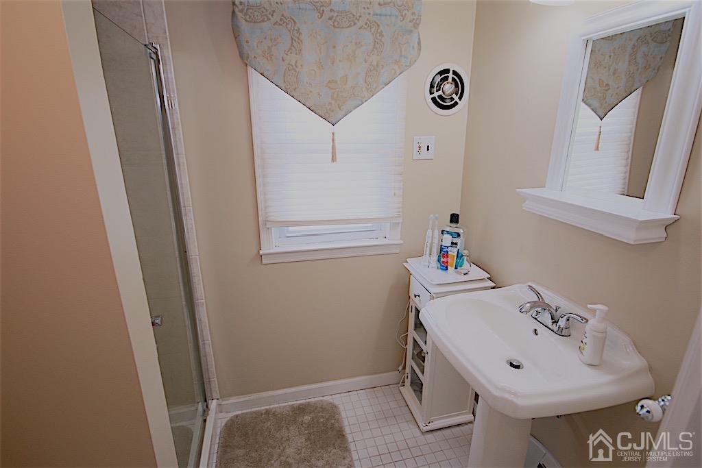 177 Midfield Road Colonia, NJ 07067 - Photo 13 of 20 a bathroom with a sink and a mirror