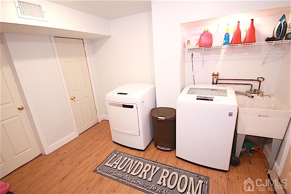 177 Midfield Road Colonia, NJ 07067 - Photo 17 of 20 a view of storage and utility room with washer and dryer