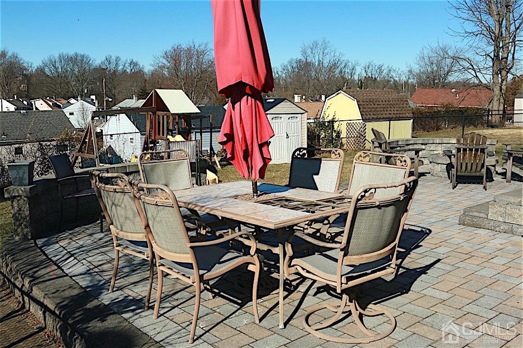 177 Midfield Road Colonia, NJ 07067 - Photo 18 of 20 a view of a dinning table and chairs in the patio