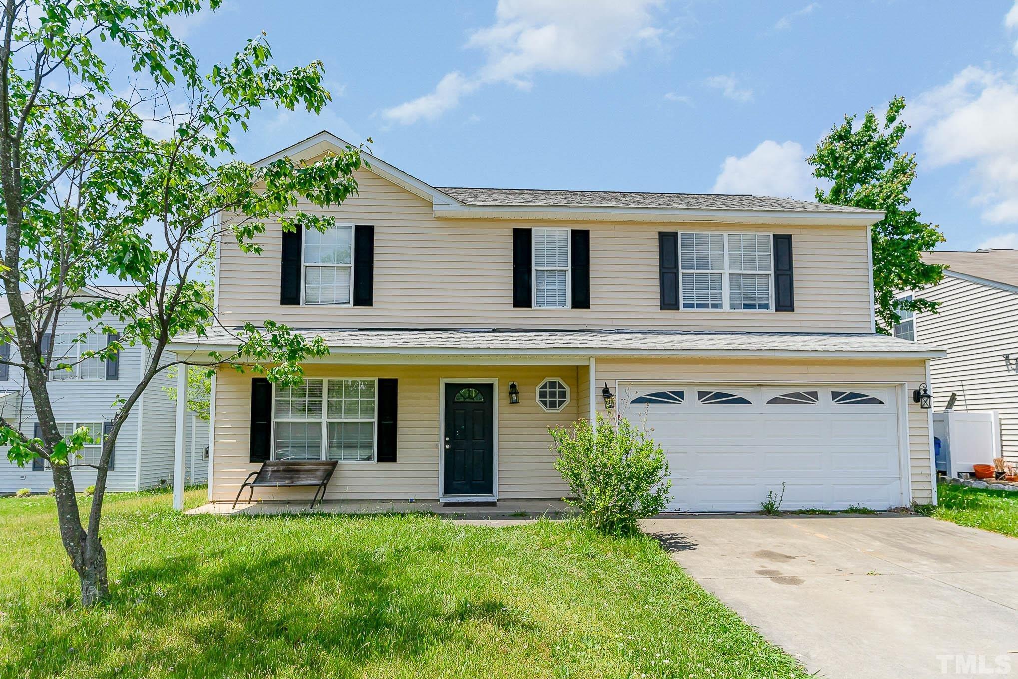 front view of a house with a yard