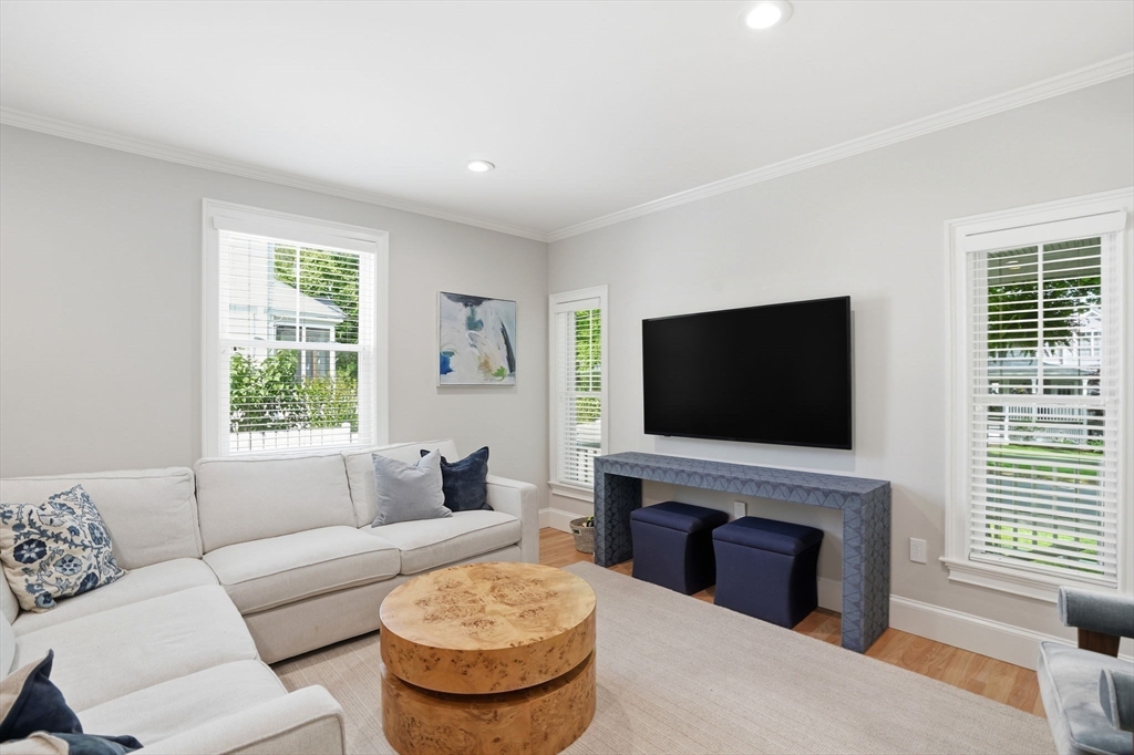 59 Elm Street Hingham, MA 02043 - Photo 4 of 33 a living room with furniture a fireplace and a flat screen tv