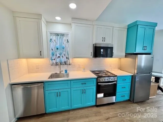 a kitchen with granite countertop a stove and a refrigerator