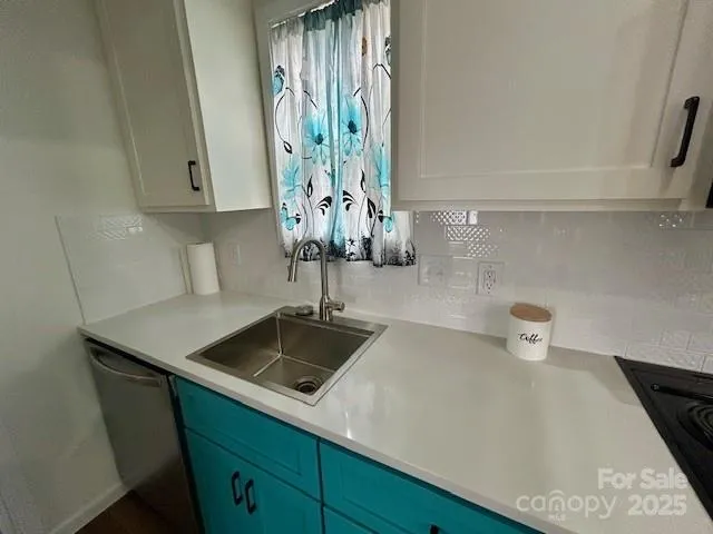 a kitchen with a sink and cabinets