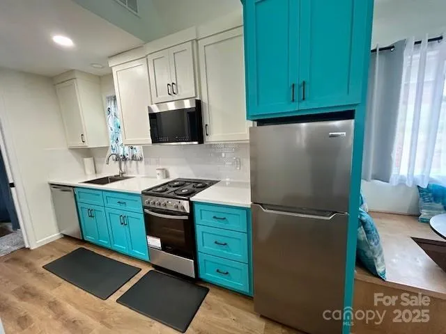 a kitchen with stainless steel appliances granite countertop a refrigerator stove and microwave