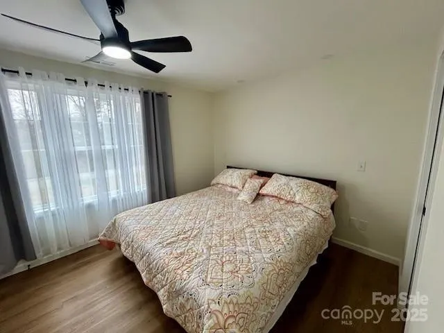 a bed sitting in a bedroom next to a window