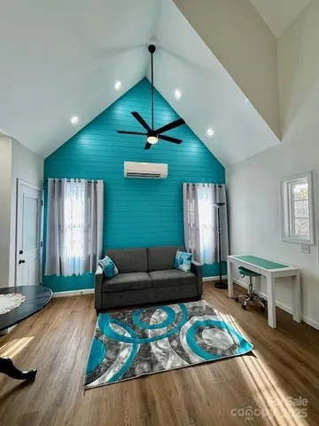 a living room with furniture and a wooden floor