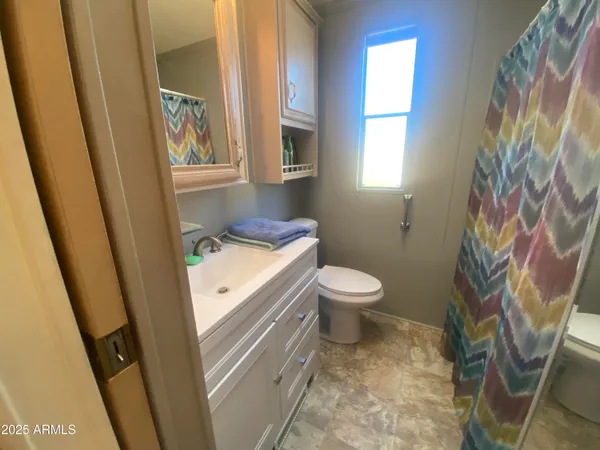 a bathroom with a toilet sink and a mirror