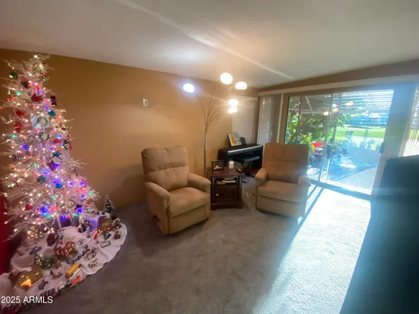 a living room with furniture and flowers
