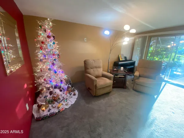 a living room with furniture and a floor to ceiling window