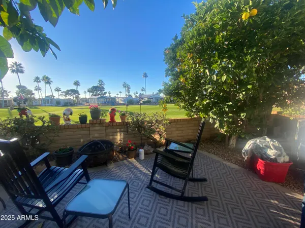 a view of a chairs and table in the patio