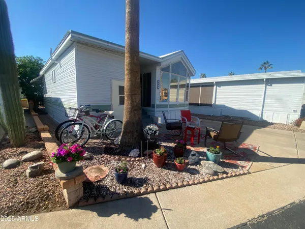 a view of a house with patio furniture