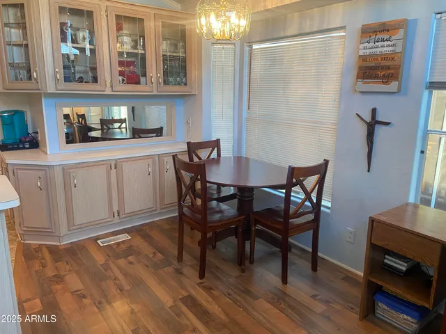 a view of a dining room with furniture and wooden floor