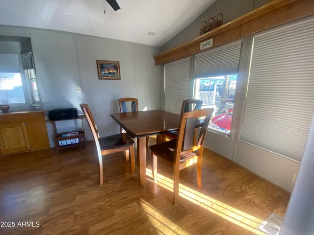 a view of a dining room with furniture and wooden floor