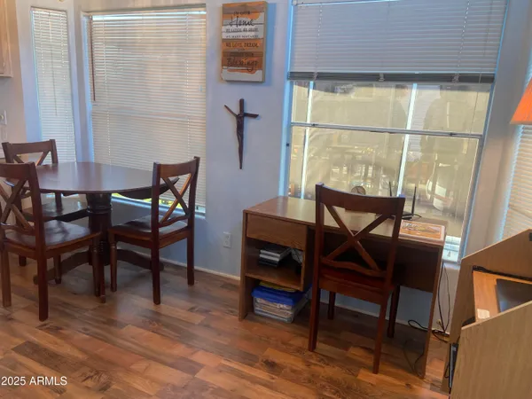 a view of a dining room with furniture and wooden floor