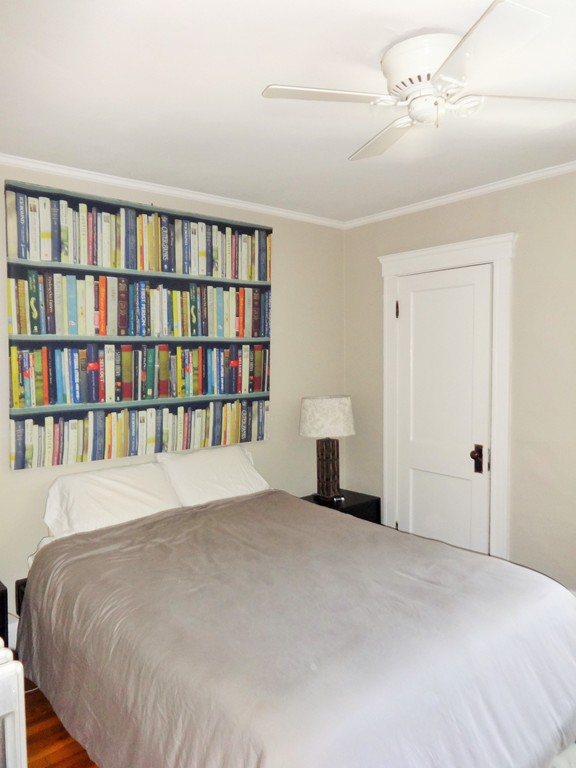 37 Everett Street, Unit 3 Waltham, MA 02453 - Photo 6 of 16 a bedroom with a bed and a book shelf