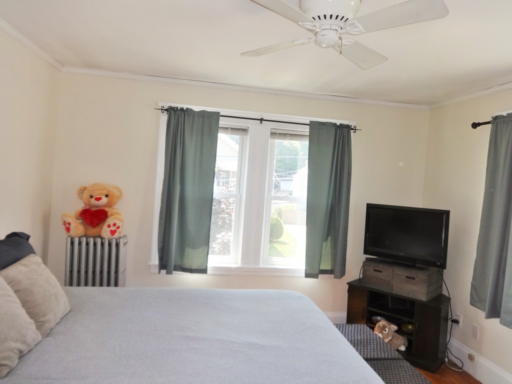 37 Everett Street, Unit 3 Waltham, MA 02453 - Photo 8 of 16 a bedroom with a bed and flat screen tv