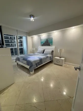 a spacious bedroom with a bed and window