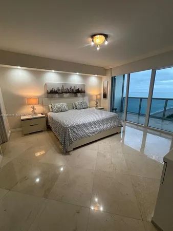 a room with a bed and a lamp with table