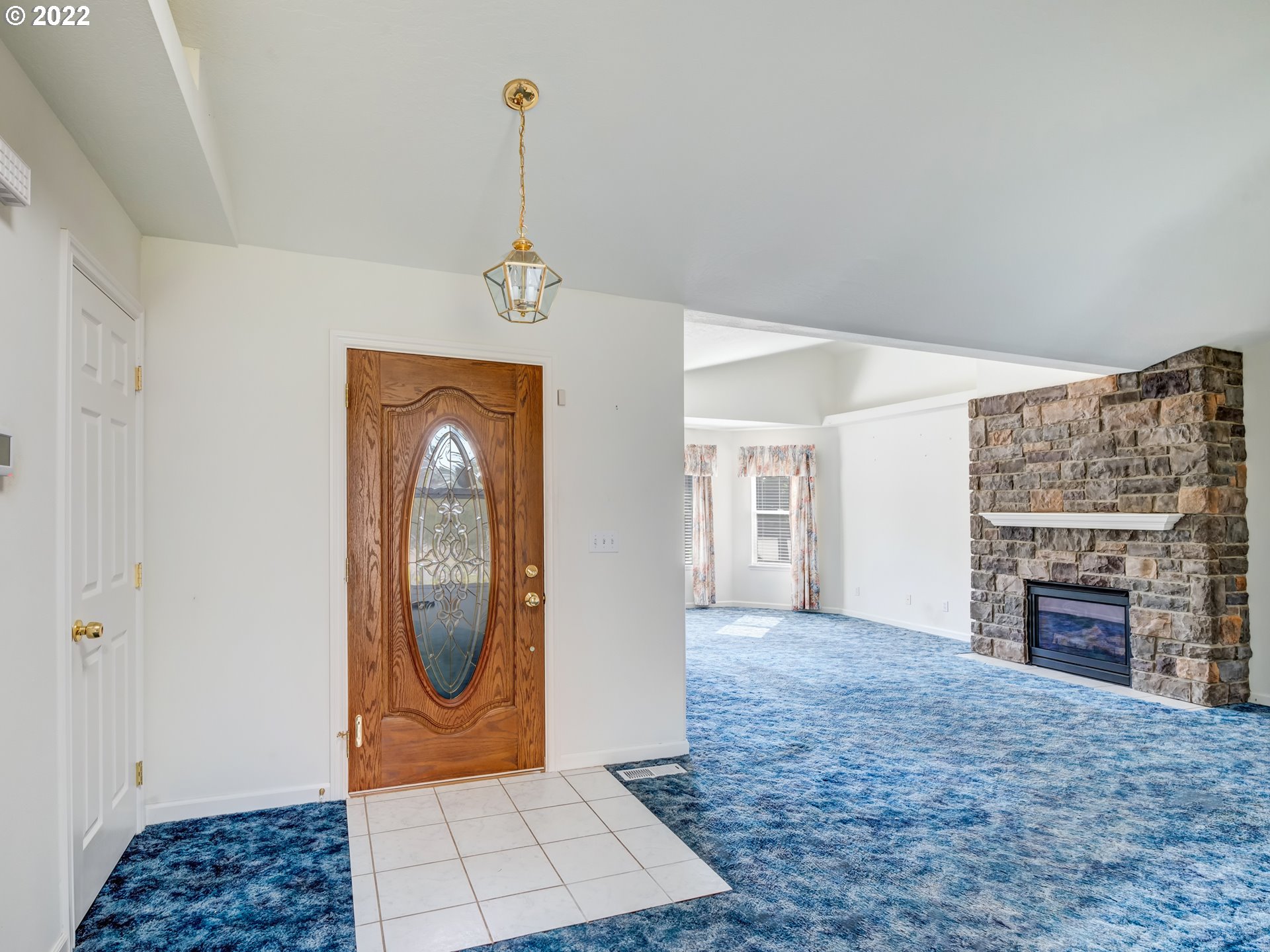 924 S Street Springfield, OR 97477 - Photo 4 of 30 a view of a livingroom with a fireplace a chandelier and wooden floor