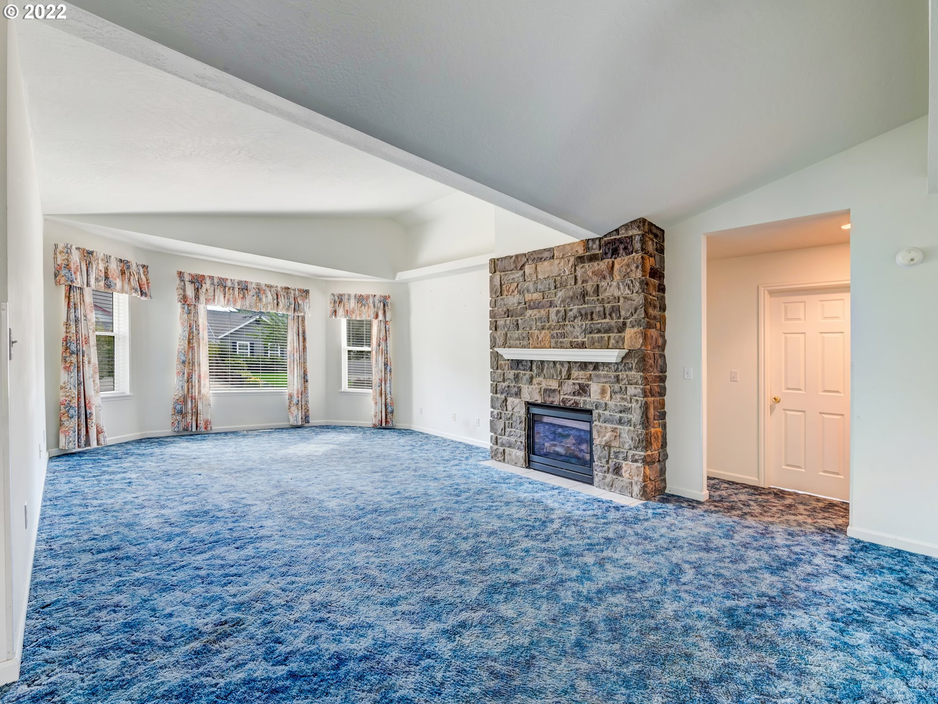 924 S Street Springfield, OR 97477 - Photo 5 of 30 a view of an empty room with a fireplace and a window