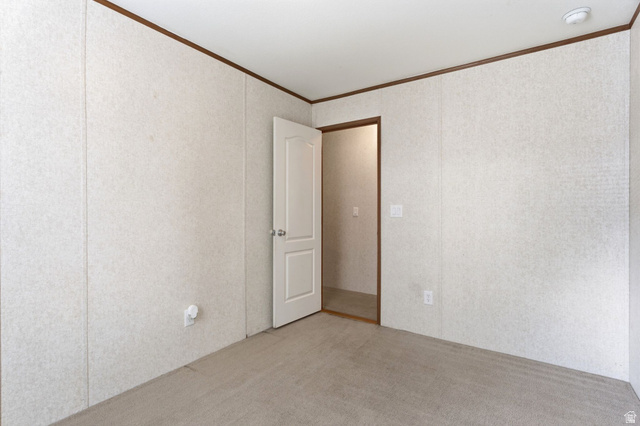 2875 North Hill Field Road, Unit 62 Layton, UT 84041 - Photo 22 of 34 Carpeted room with light-toned wall panels, white trim, and a white interior door