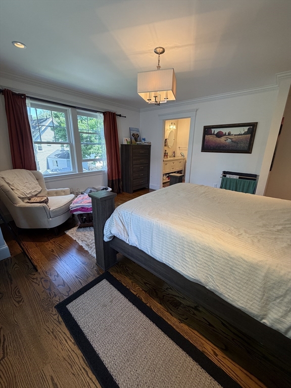 17 Cardinal Street, Unit 17 Winchester, MA 01890 - Photo 17 of 42 a bedroom with a bed and wooden floor