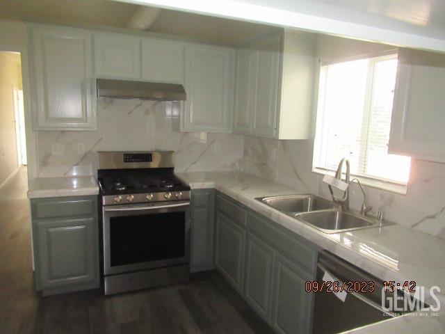 Undisclosed Address Taft, CA 93268 - Photo 11 of 28 a kitchen with stainless steel appliances granite countertop a sink stove and cabinets