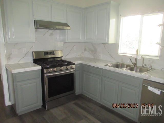 Undisclosed Address Taft, CA 93268 - Photo 7 of 28 a kitchen with granite countertop a sink stove and cabinets