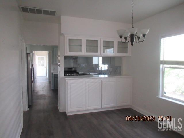 Undisclosed Address Taft, CA 93268 - Photo 8 of 28 a kitchen with a refrigerator and white cabinets