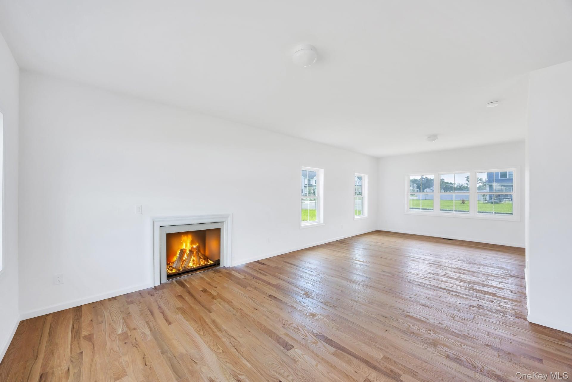 Lot #4 Cardinal Court Ridge, NY 11961 - Photo 18 of 48 an empty room with a window and a fireplace