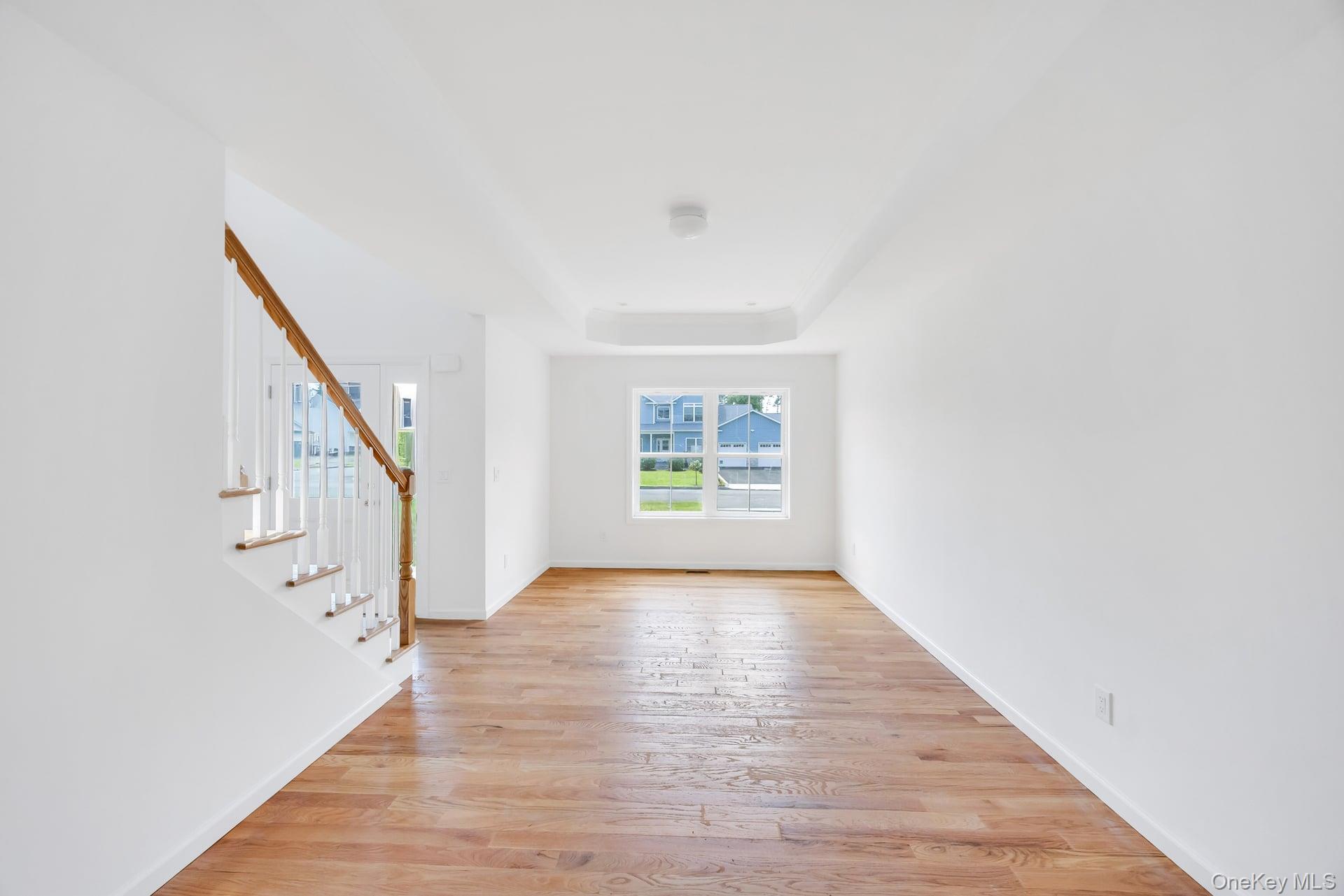 Lot #4 Cardinal Court Ridge, NY 11961 - Photo 21 of 48 a view of an empty room with wooden floor and a window