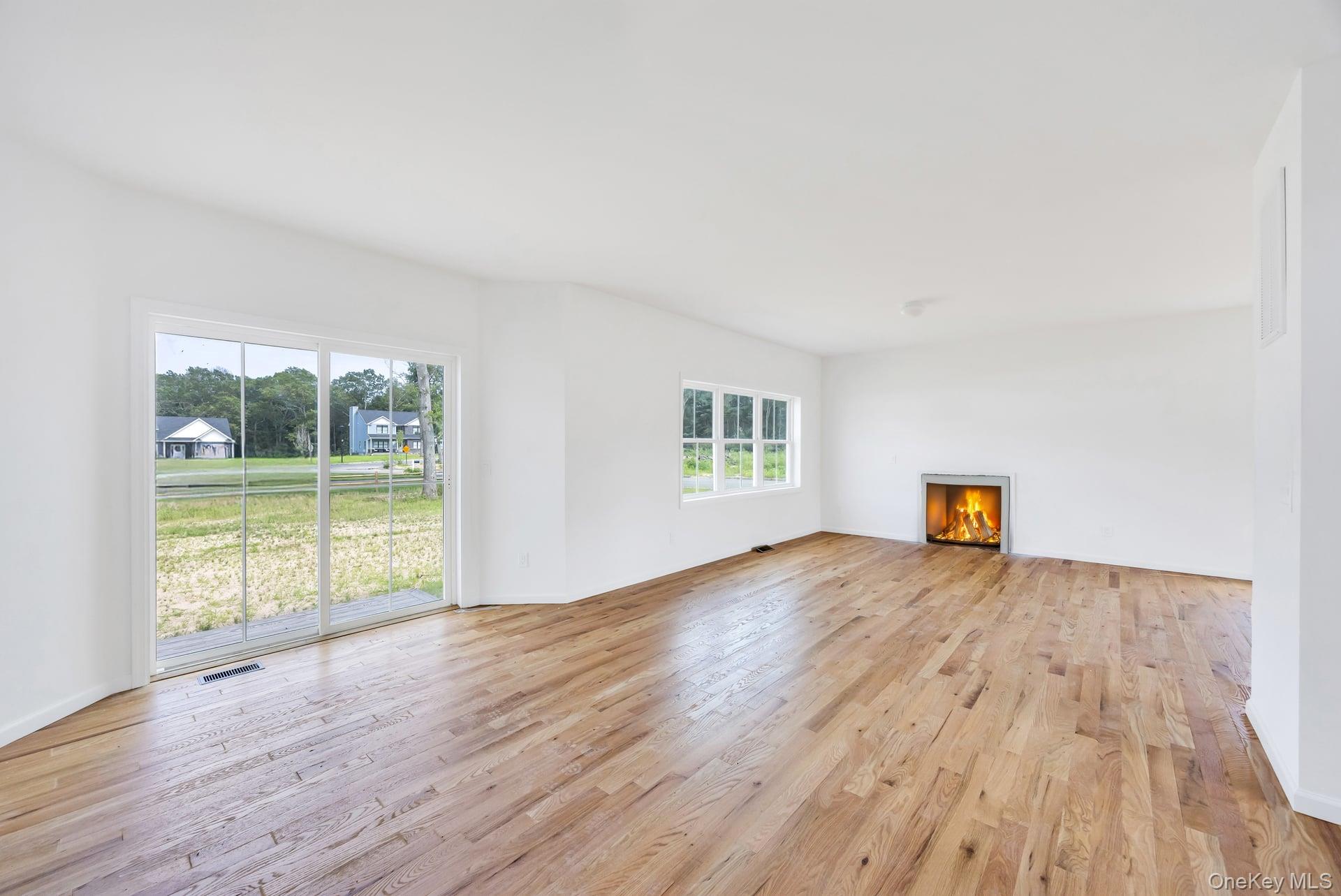 Lot #4 Cardinal Court Ridge, NY 11961 - Photo 22 of 48 a view of an empty room with wooden floor and a window